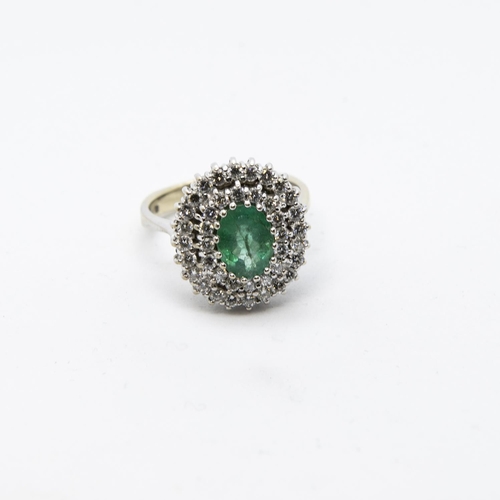 334 - An Emerald and Diamond Cluster Ring, claw-set oval-cut emerald within double frame of brilliant-cut ... 