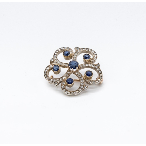 362 - A French Sapphire and Diamond Brooch, the openwork plaque claw-set round sapphire within five smalle... 