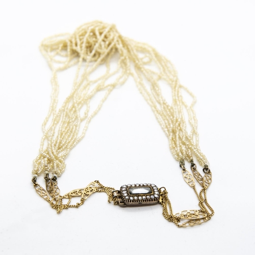 376 - A 19th Century Seed Pearl Necklace of ten strands of pearls on three fine gold chains (later additio... 