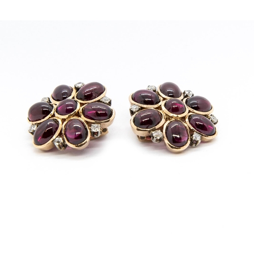 380 - A Pair of Garnet and Diamond Flower Cluster Ear Clips set round garnet cabochon within six oval garn... 