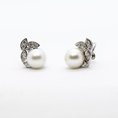 387 - A pair of Diamond and Cultured Pearl Earrings each with leafage mount pavé-set eight brilliant-cut d... 