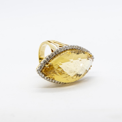 388 - A Citrine and Diamond Cocktail Ring, claw-set large faceted marquise-shaped citrine within a frame o... 