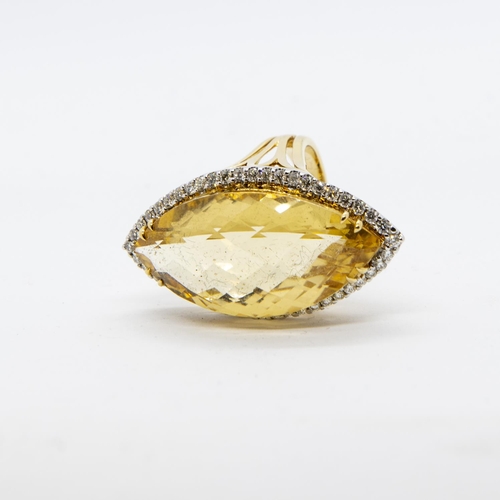 388 - A Citrine and Diamond Cocktail Ring, claw-set large faceted marquise-shaped citrine within a frame o... 