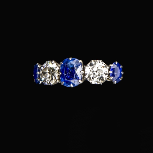 409 - A Sapphire and Diamond five stone Ring, claw-set three graduated cushion-cut sapphires interspersed ... 