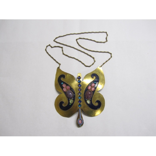 416 - A fantasy Butterfly Pendant set coloured glass and beads on blue enamel and brass, 4 in wide.