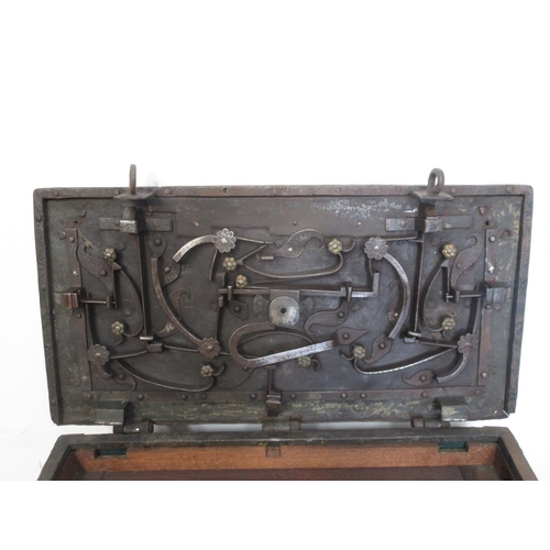 580 - An iron Armada Chest with hinged top opening to reveal ornate locking mechanism with iron carrying h... 