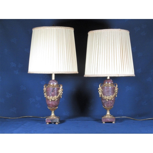 775 - A pair of mauve veined marble Table Lamps and Shades with gilt metal mounts of bacchus and trailing ... 