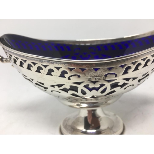 139 - An Edward VII silver pierced oval Bowl with scroll handles, blue glass liner on pedestal base, Birmi... 