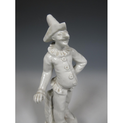 495 - A blanc de chine Italian figure of Punchinello striking a pose with stone plinth and rococo style ba... 