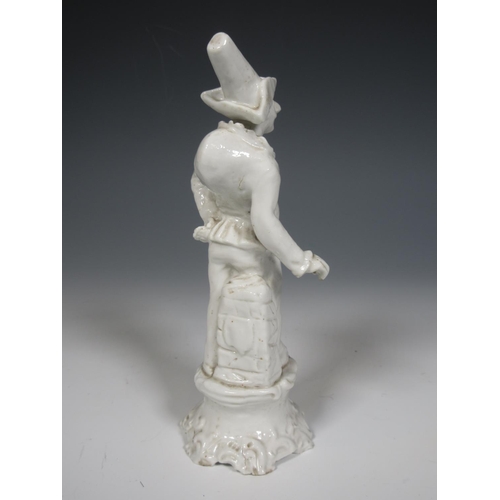 495 - A blanc de chine Italian figure of Punchinello striking a pose with stone plinth and rococo style ba... 