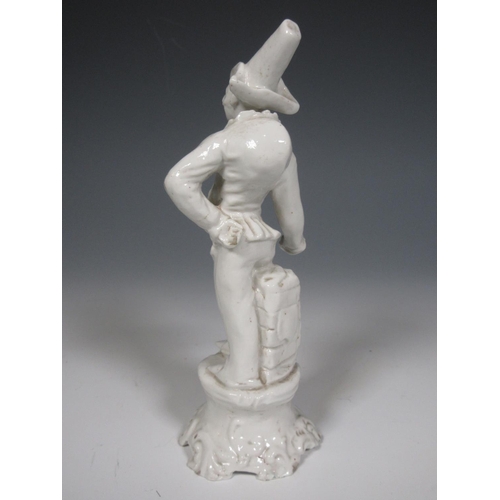 495 - A blanc de chine Italian figure of Punchinello striking a pose with stone plinth and rococo style ba... 