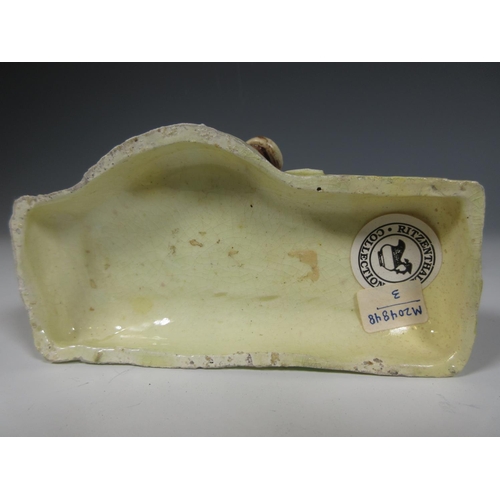 506 - An Agate ware Cow Creamer with calf at foot on a shaped platform base, the lid with moulded floral k... 