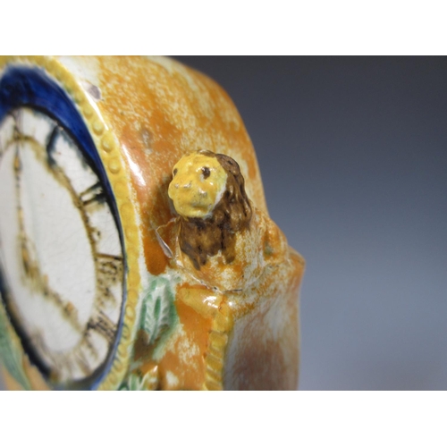 507 - An unusual Prattware model of a Longcase Clock with applied moulded acorn and leaf design, two lion ... 