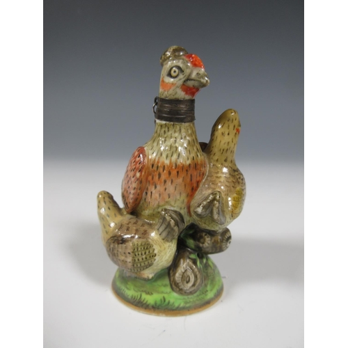 515 - A Chelsea porcelain Scent Bottle in the form of a chicken with three small hens on a circular domed ... 