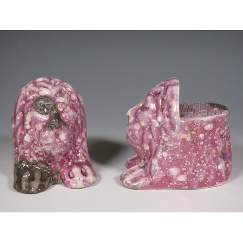 516 - A pair of early 19th Century pink lustre Window Rests in the form of moulded lion heads, one repaire... 