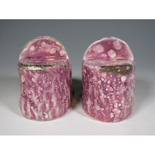 516 - A pair of early 19th Century pink lustre Window Rests in the form of moulded lion heads, one repaire... 