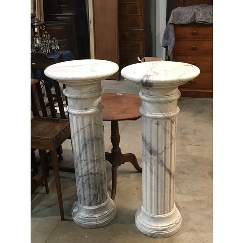 793 - A pair of white marble Corinthian type columns with circular tops and bases 3ft 7in H x 1ft 6in D