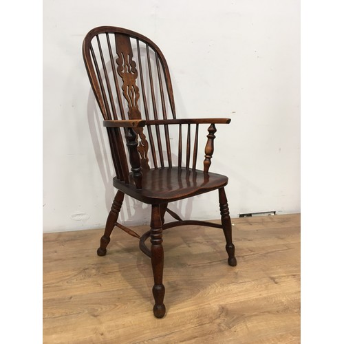 772 - An early 19th Century Windsor Elbow Chair with pierced splat and stick back, solid seat on turned le... 