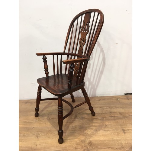 772 - An early 19th Century Windsor Elbow Chair with pierced splat and stick back, solid seat on turned le... 