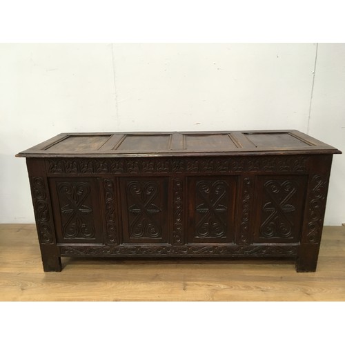 518 - A 17th Century oak Coffer with sunken four panel lid above leafage frieze and four panel front carve... 