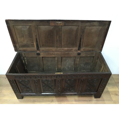 518 - A 17th Century oak Coffer with sunken four panel lid above leafage frieze and four panel front carve... 