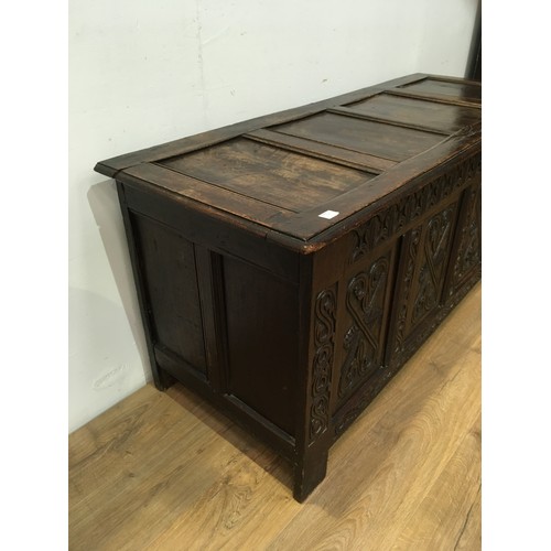 518 - A 17th Century oak Coffer with sunken four panel lid above leafage frieze and four panel front carve... 