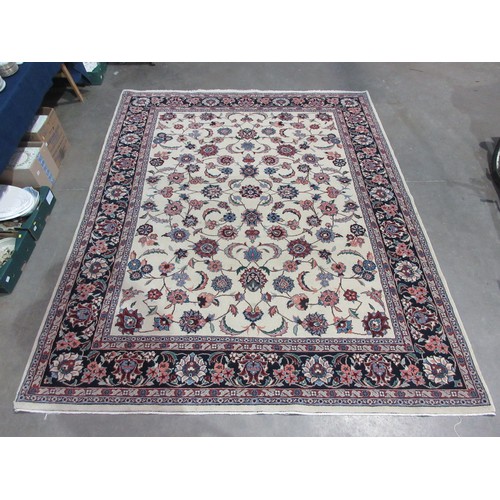 768 - A cream ground woollen Carpet with trailing floral design with a dark blue tramline border with flor... 