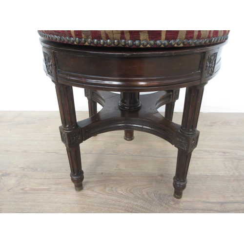 121 - A 19th Century mahogany revolving Piano Stool with Egyptian decorated cushioned seat mounted upon re... 