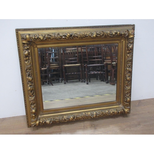 135 - A 19th Century gilt framed Wall Mirror with relief fruit and wheat decoration 3ft 2in W x 2ft 8in H