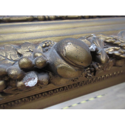 135 - A 19th Century gilt framed Wall Mirror with relief fruit and wheat decoration 3ft 2in W x 2ft 8in H