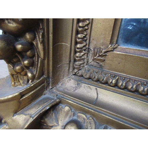 135 - A 19th Century gilt framed Wall Mirror with relief fruit and wheat decoration 3ft 2in W x 2ft 8in H