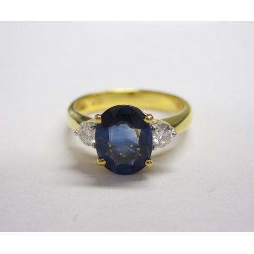 186 - A Sapphire and Diamond three stone Ring claw-set oval-cut sapphire between two brilliant-cut diamond... 