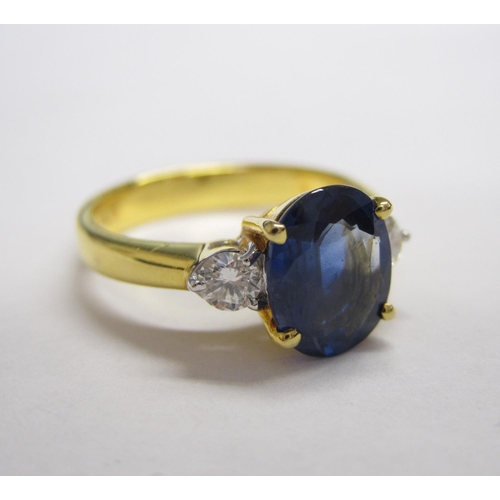 186 - A Sapphire and Diamond three stone Ring claw-set oval-cut sapphire between two brilliant-cut diamond... 