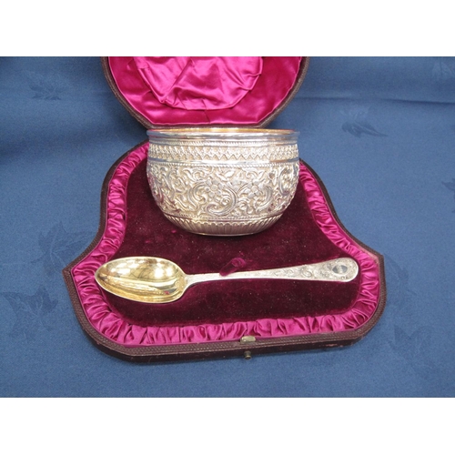 199 - A Victorian silver Bowl and Spoon with detailed floral and scroll embossing, London 1884, cased.