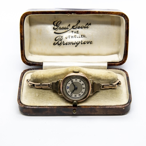 227 - A Lady's 1930's Wristwatch, the round silvered dial with black Arabic numerals in 9ct gold case on e... 