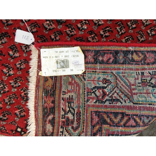 311 - A Persian style Rug, with central lozenge on a red ground 6ft 7in x 4ft 5in, repaired