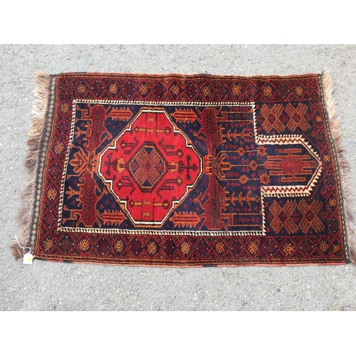 312 - A red Turcoman multi-bordered Rug with central medallions on a cream ground, 6ft 7in x 3ft, and a Ba... 