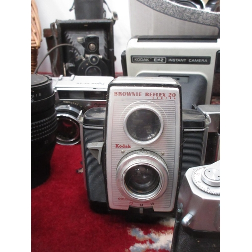 397 - A wicker hamper and a box of Cameras and Lenses including Bell & Howell, Mamiya, Kodak, etc