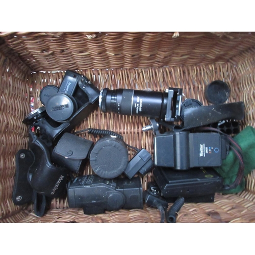 397 - A wicker hamper and a box of Cameras and Lenses including Bell & Howell, Mamiya, Kodak, etc