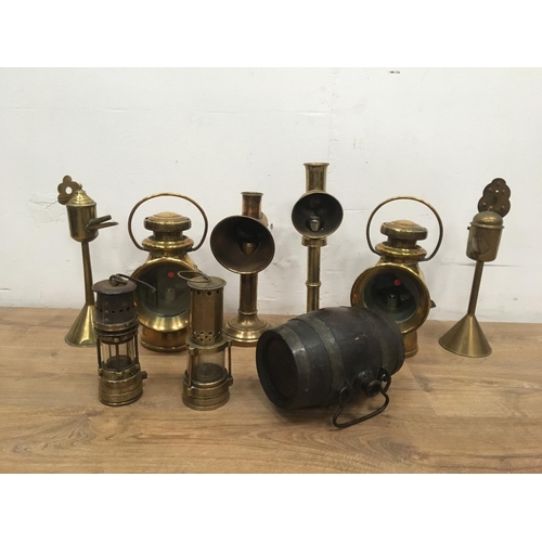 404A - A quantity of brassware including two Miner's Lamps, two carriage Lamps, other Lamps and a small Bar... 