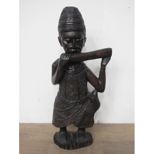 432 - A carved hardwood Tribal Figure playing an instrument 2ft 1in H