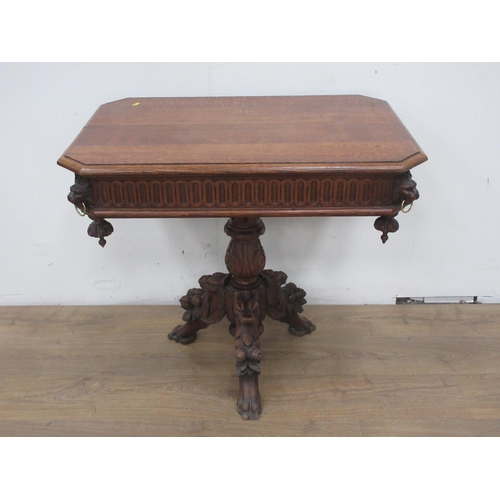 443 - A reproduction Victorian style oak Centre Table with lion mask and ring decoration mounted upon leaf... 