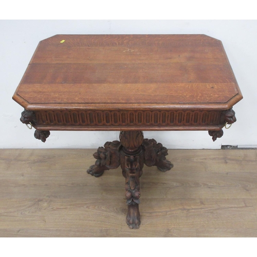 443 - A reproduction Victorian style oak Centre Table with lion mask and ring decoration mounted upon leaf... 