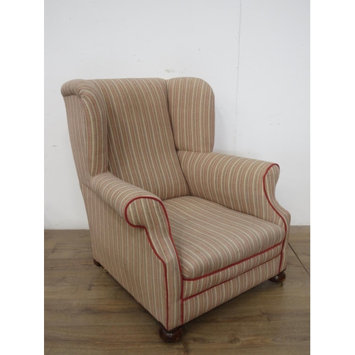 516 - An antique Wingback Armchair with pink and cream striped upholstery on bun feet and casters 3ft 1in ... 