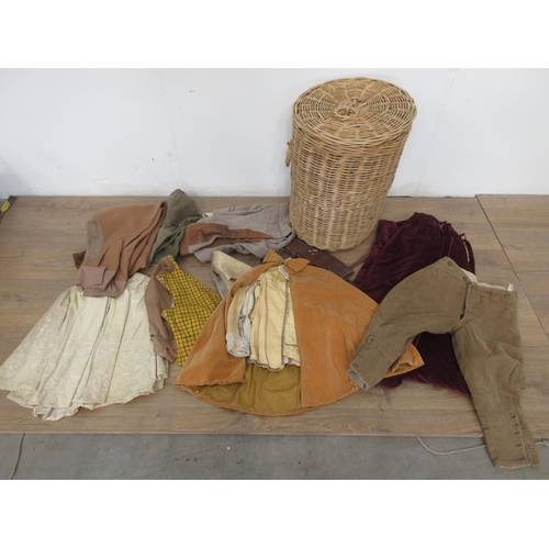 521 - A wicker Linen Basket containing a quantity of old costume including Waistcoats, Cape and Breeches