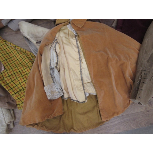 521 - A wicker Linen Basket containing a quantity of old costume including Waistcoats, Cape and Breeches