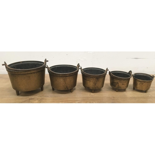 522A - Five graduated brass Pans with iron swing handles, 6in to 3in