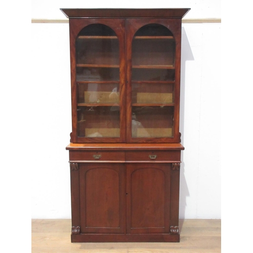 527 - A Victorian walnut and glazed two door Bookcase enclosing adjustable shelves the base fitted two dra... 