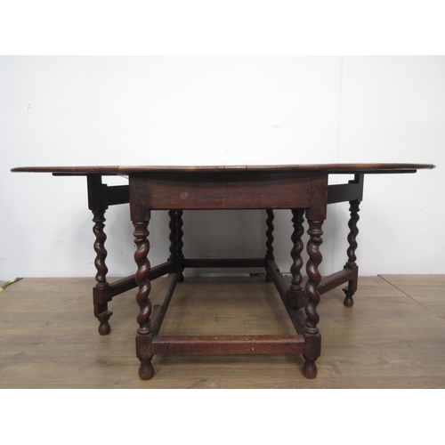 539 - An antique oak Gateleg Dining Table on barleytwist supports united by stretchers 4ft W x 2ft 5in H