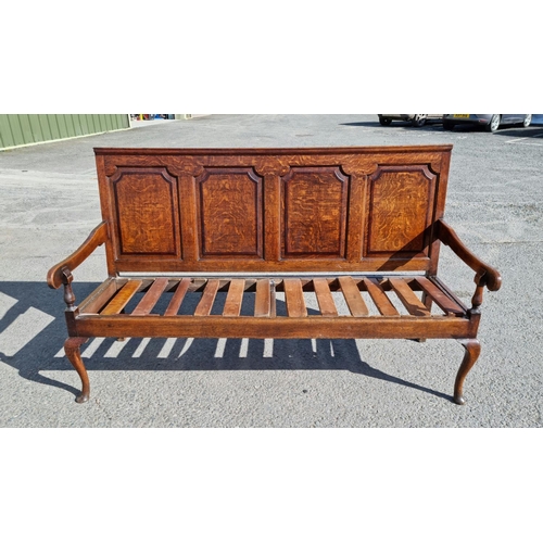 550 - An 18th Century oak Settle with four panel back on cabriole supports and pad feet 6ft W x 3ft 6in H